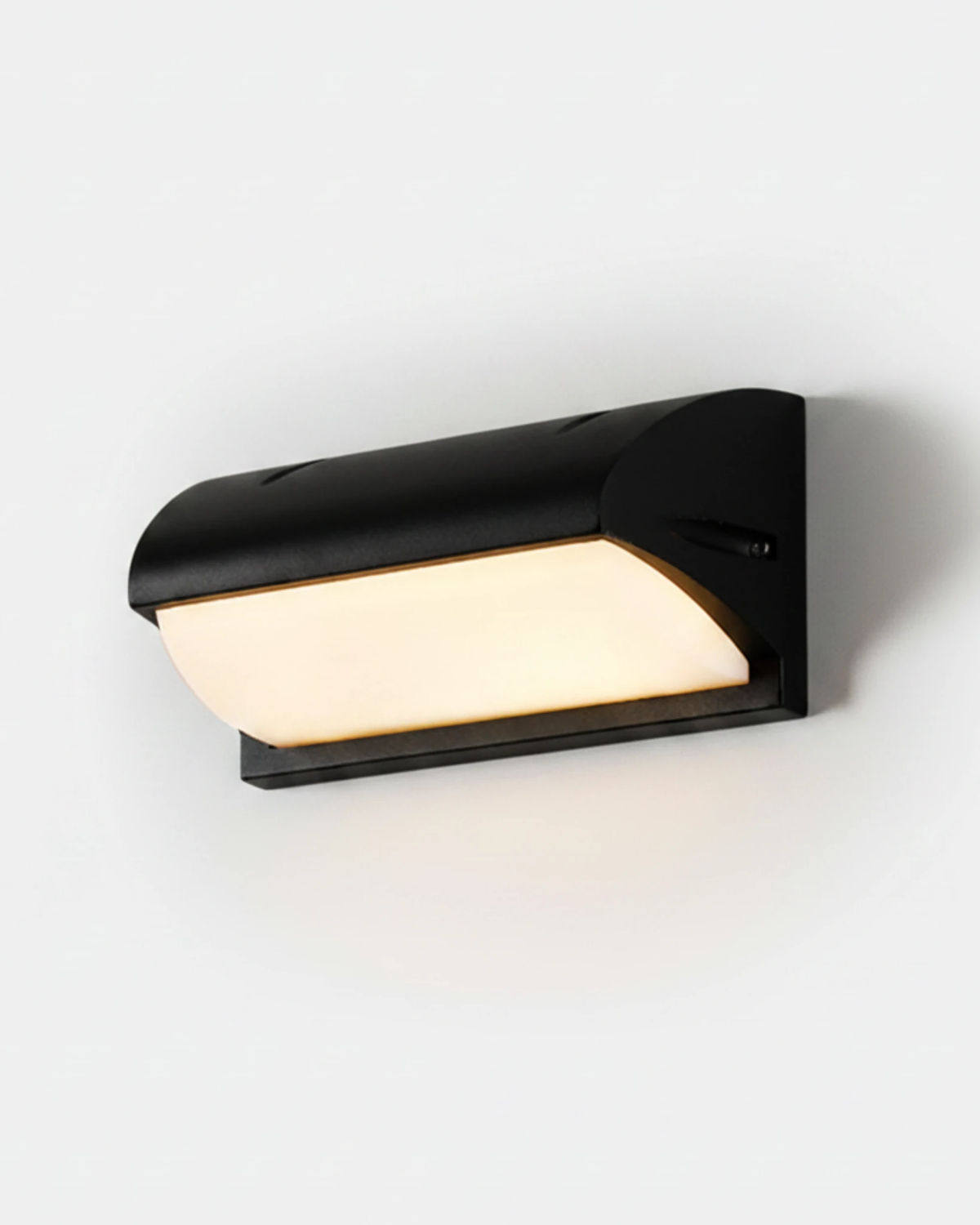 Outdoor wall sconce NOTO No.04 Large 12 in, black hooded visor sconce with its opal panel switched on