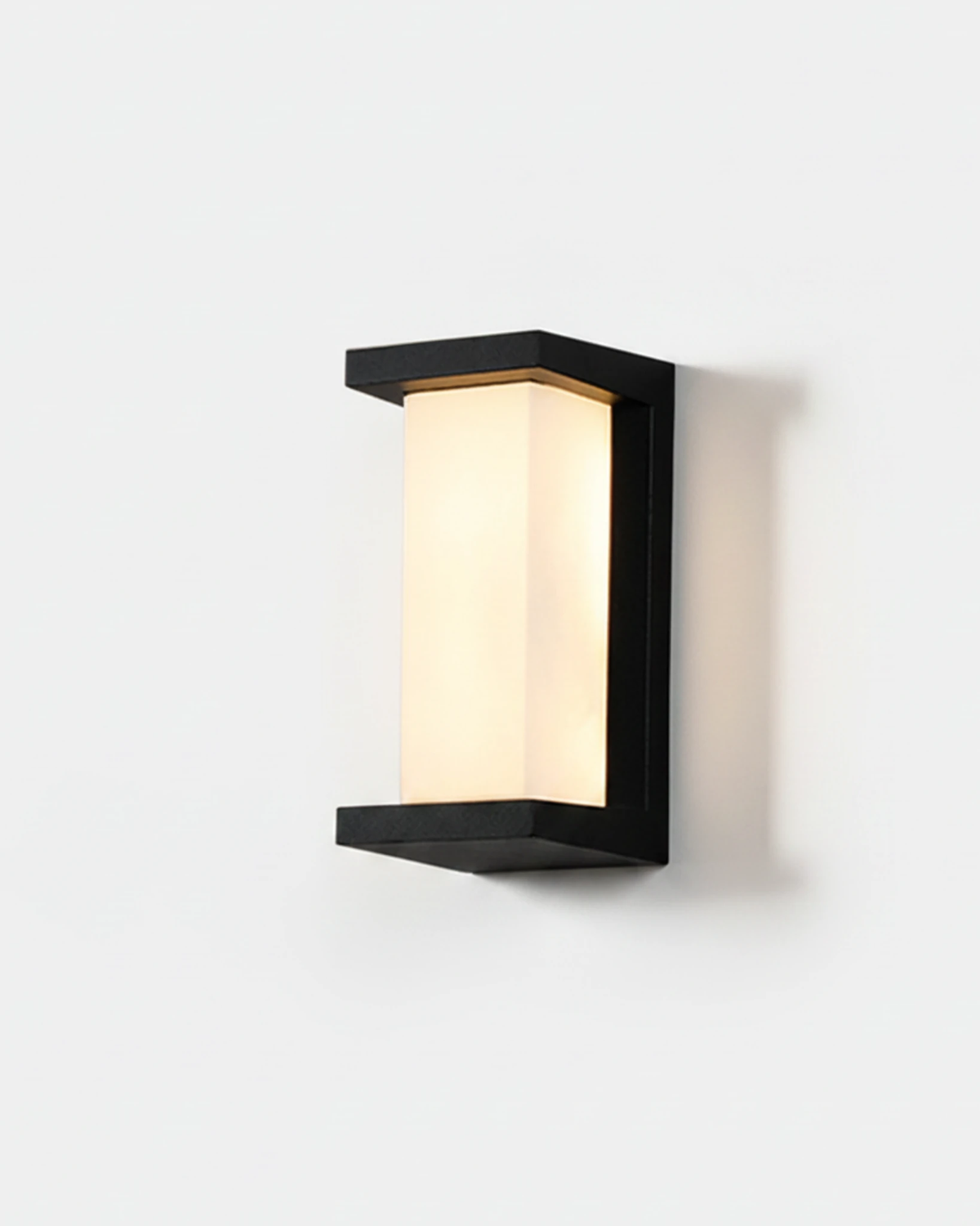 Outdoor wall sconce PORTICO No.02 Large, slim black bracket with a glowing frosted column, front view