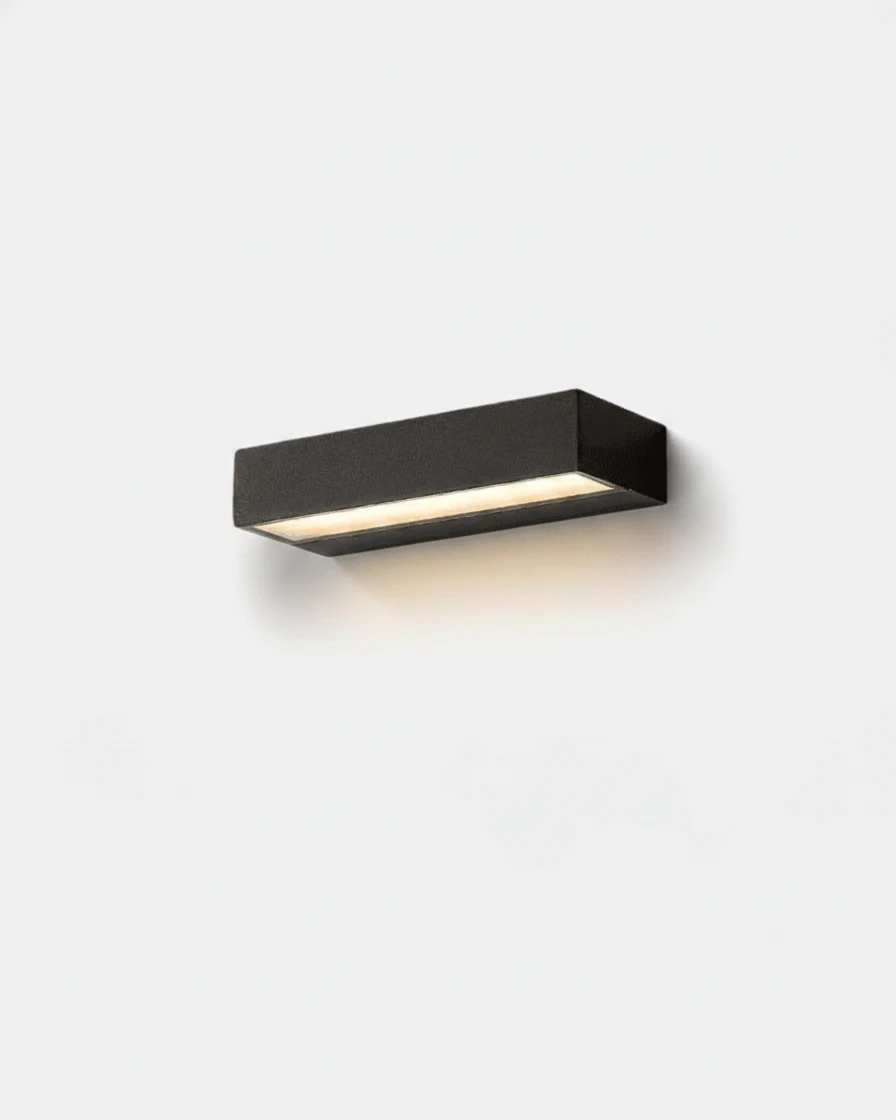 Outdoor wall sconce FORTE No.01 20 cm in matte black, slim aluminum bar switched on against a white wall