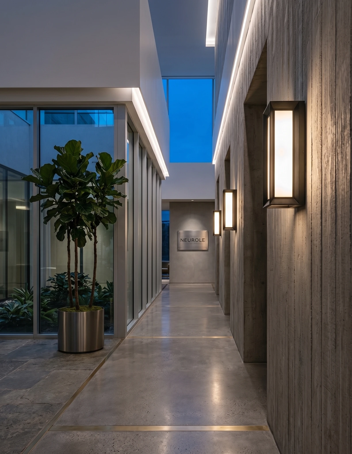 Outdoor wall sconce PORTICO No.01, lanterns lit along a covered walkway wall beside a courtyard with plants