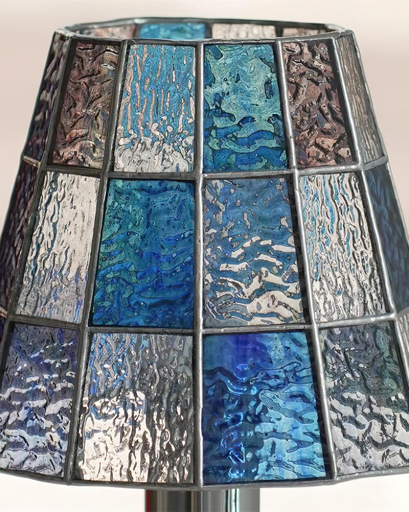 Close-up of the cobalt blue textured glass mosaic shade of the VETRA No.01 stained glass table lamp, lit