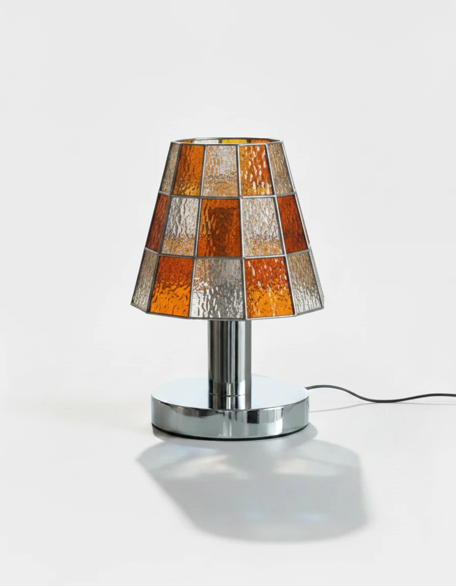 Stained glass table lamp VETRA No.01 in vibrant orange, mosaic cone shade on a chrome base, lit