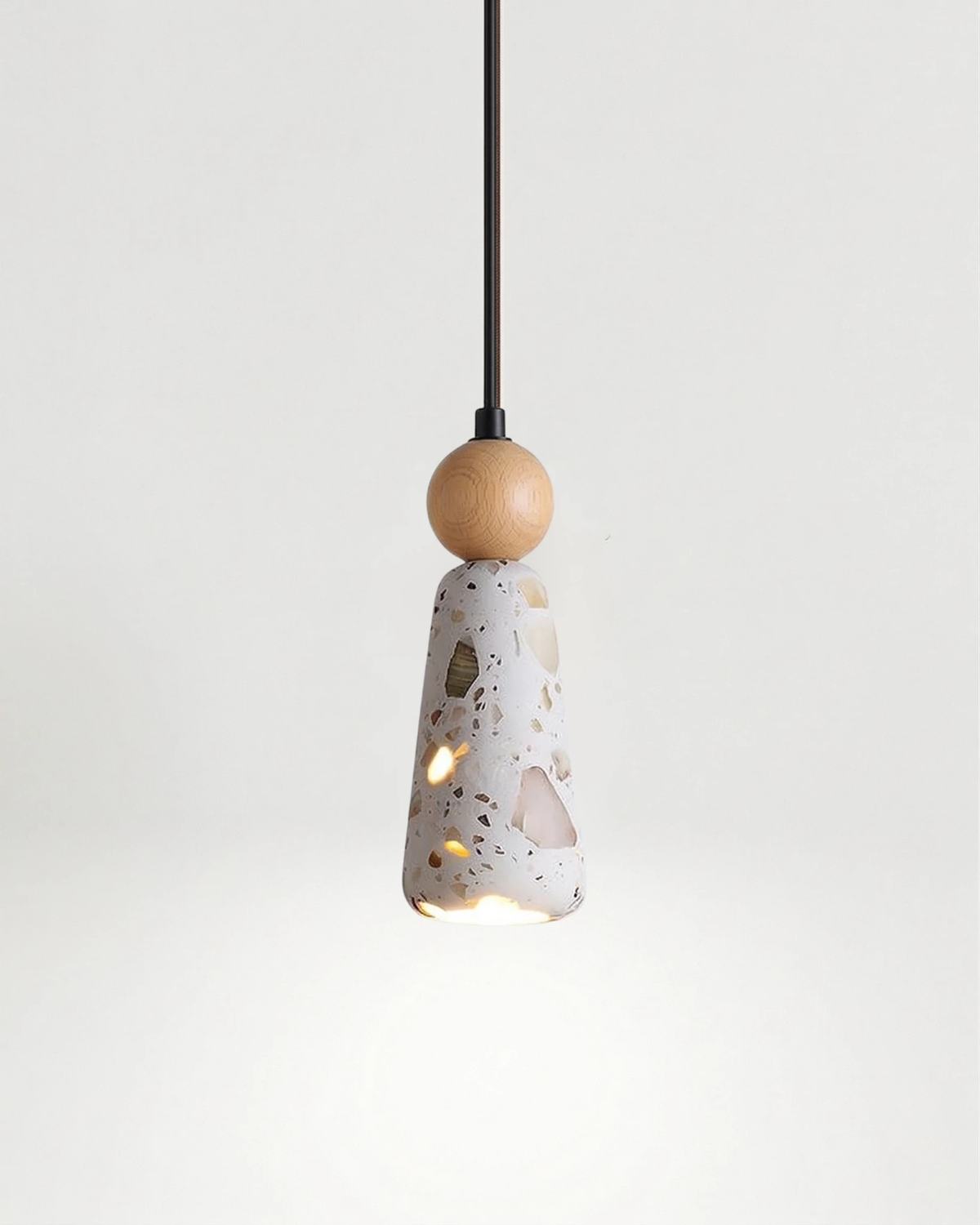 Terrazzo pendant light GROTTA No.01 totem with natural wood ball, cone shade lit against a plain background