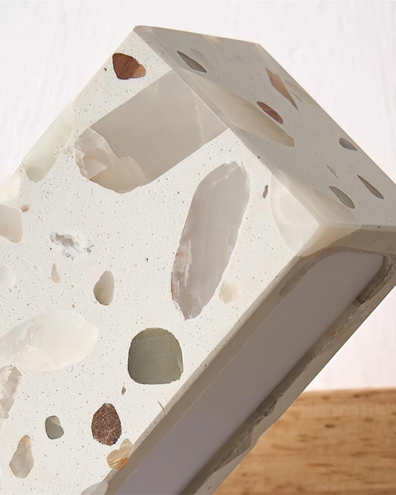 Close-up of the terrazzo surface of the terrazzo wall sconce PIETRA No.07 showing marble and stone chips