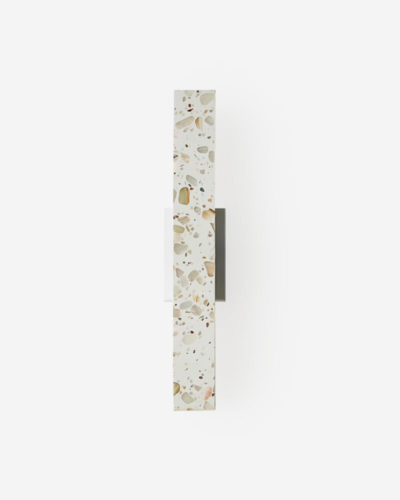 Terrazzo wall sconce PARMA No.01, slim vertical bar of beige terrazzo with marble chips on a white wall, unlit