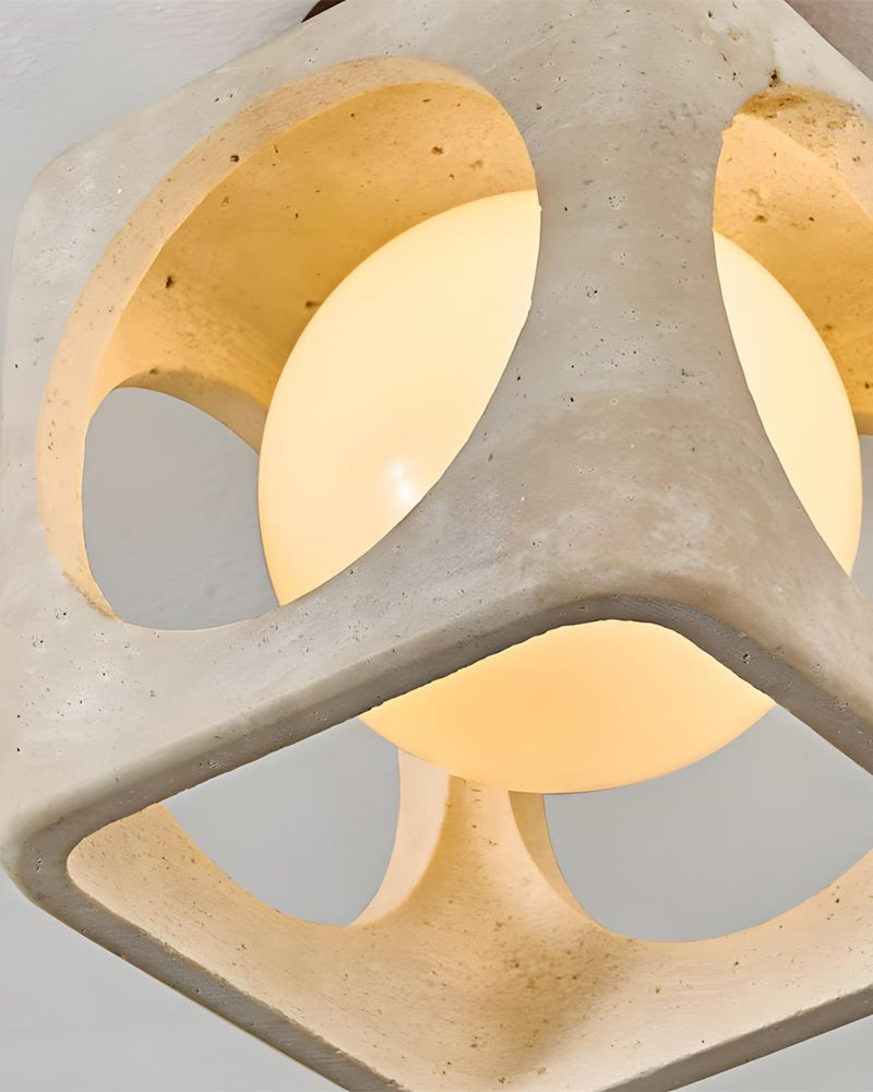 Close-up from below of the travertine flush mount ceiling light CUBA No.01 with the lit sphere in its round portals