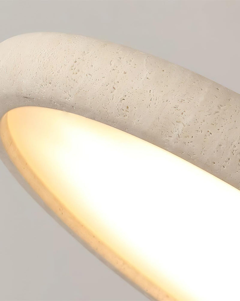 Close-up of the lit travertine rim of the LUNA No.02 flush mount ceiling light showing the stone's pores