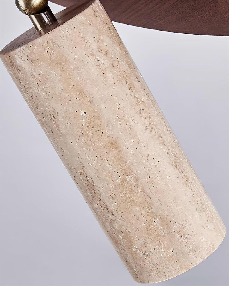 Close-up of one travertine cylinder spot beneath the walnut disc of the RAGGI No.02 travertine flush mount ceiling light