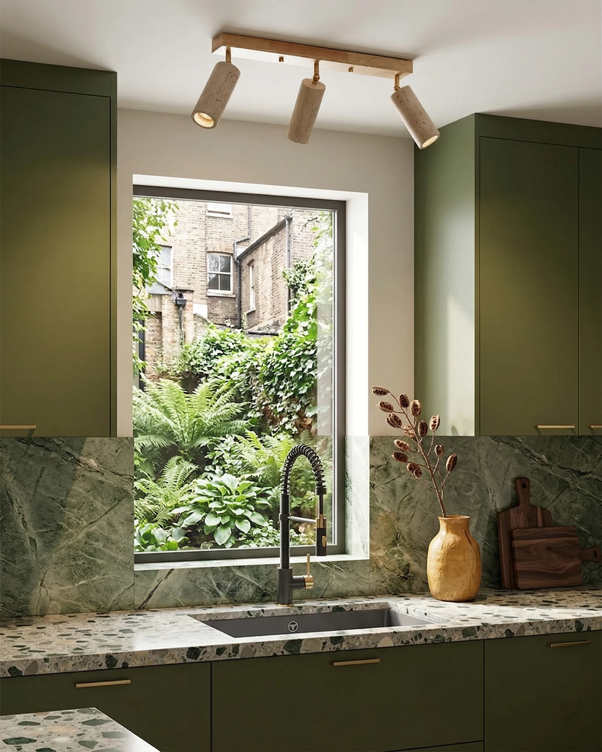 Travertine flush mount ceiling light PIETRA No.04 on the ceiling of a green kitchen with a marble backsplash and window