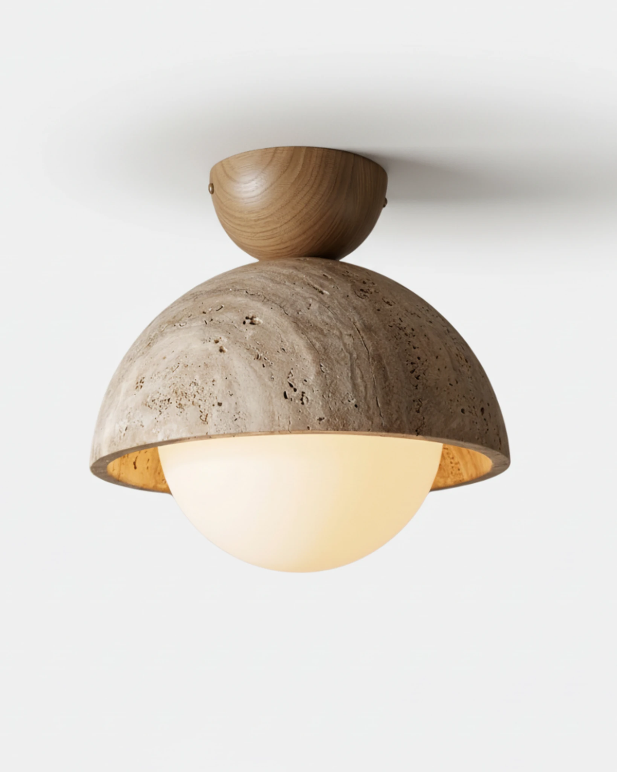 Travertine flush mount ceiling light LUNA No.06 in the 9 in size, Light Oak canopy above a wide travertine dome, lit