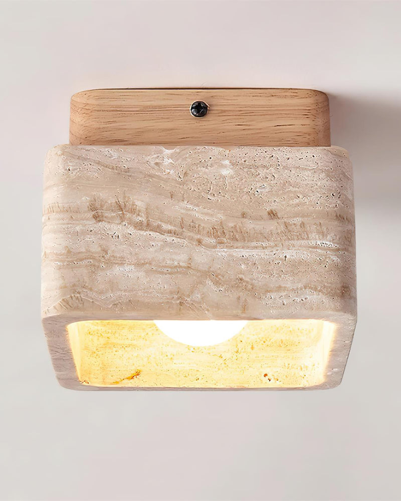 Travertine flush mount ceiling light CARSO No.01 natural wood canopy, angled view with the block glowing warm