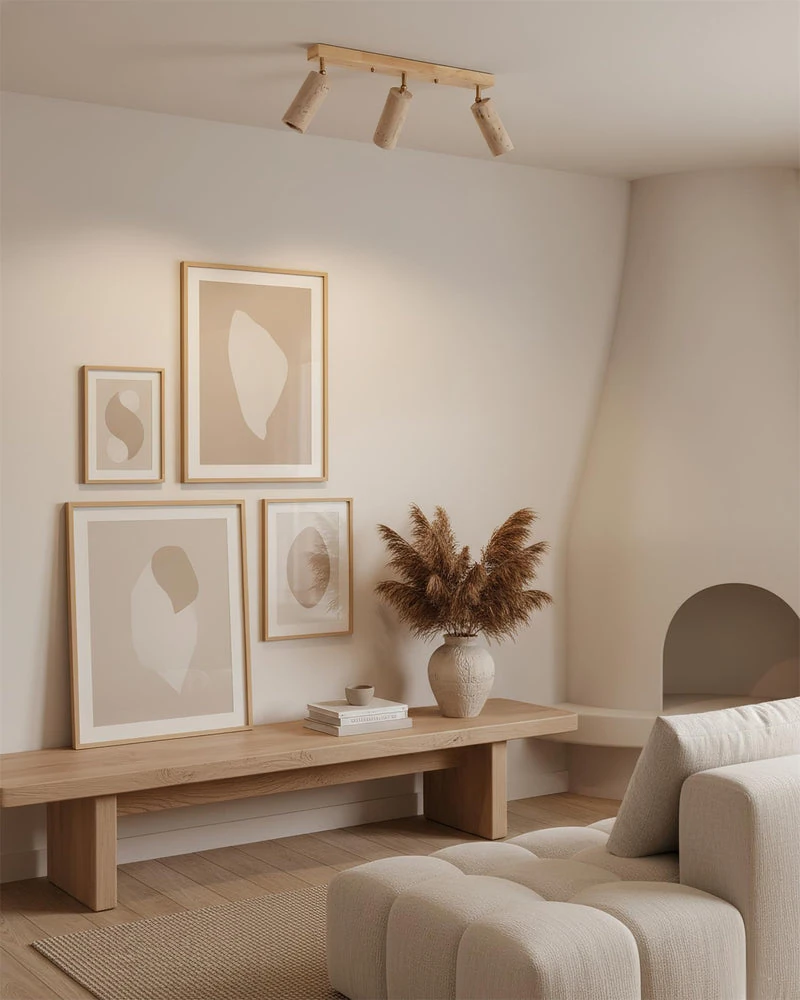 Travertine flush mount ceiling light PIETRA No.04 in natural wood above a living room with framed art and a bench