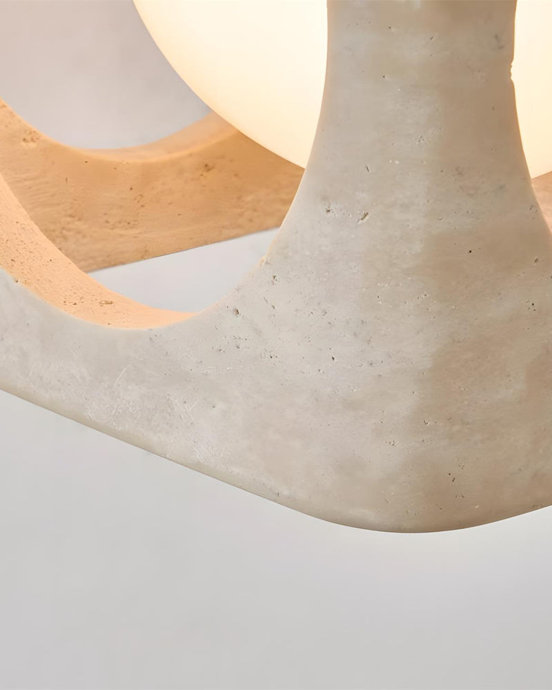 Close-up of a travertine cube corner and glowing opal sphere on the travertine pendant light CUBA No.02