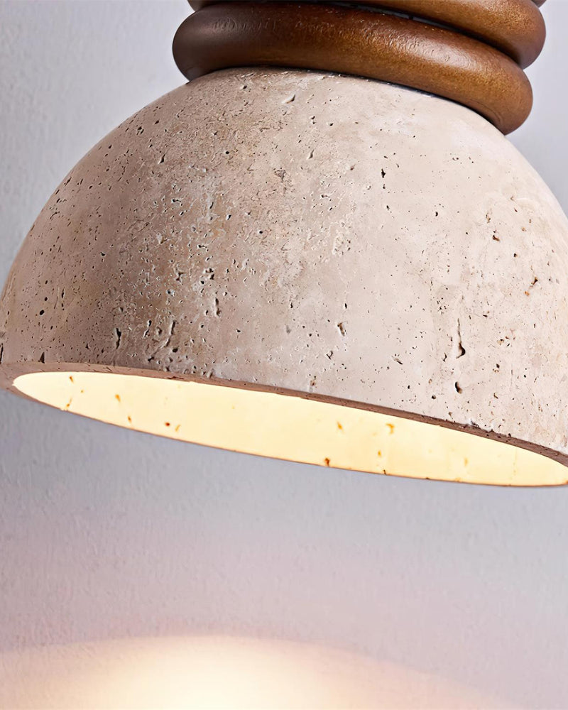 Close-up of the rim of the DOMUS No.03 travertine pendant light, dome switched on with walnut rings above