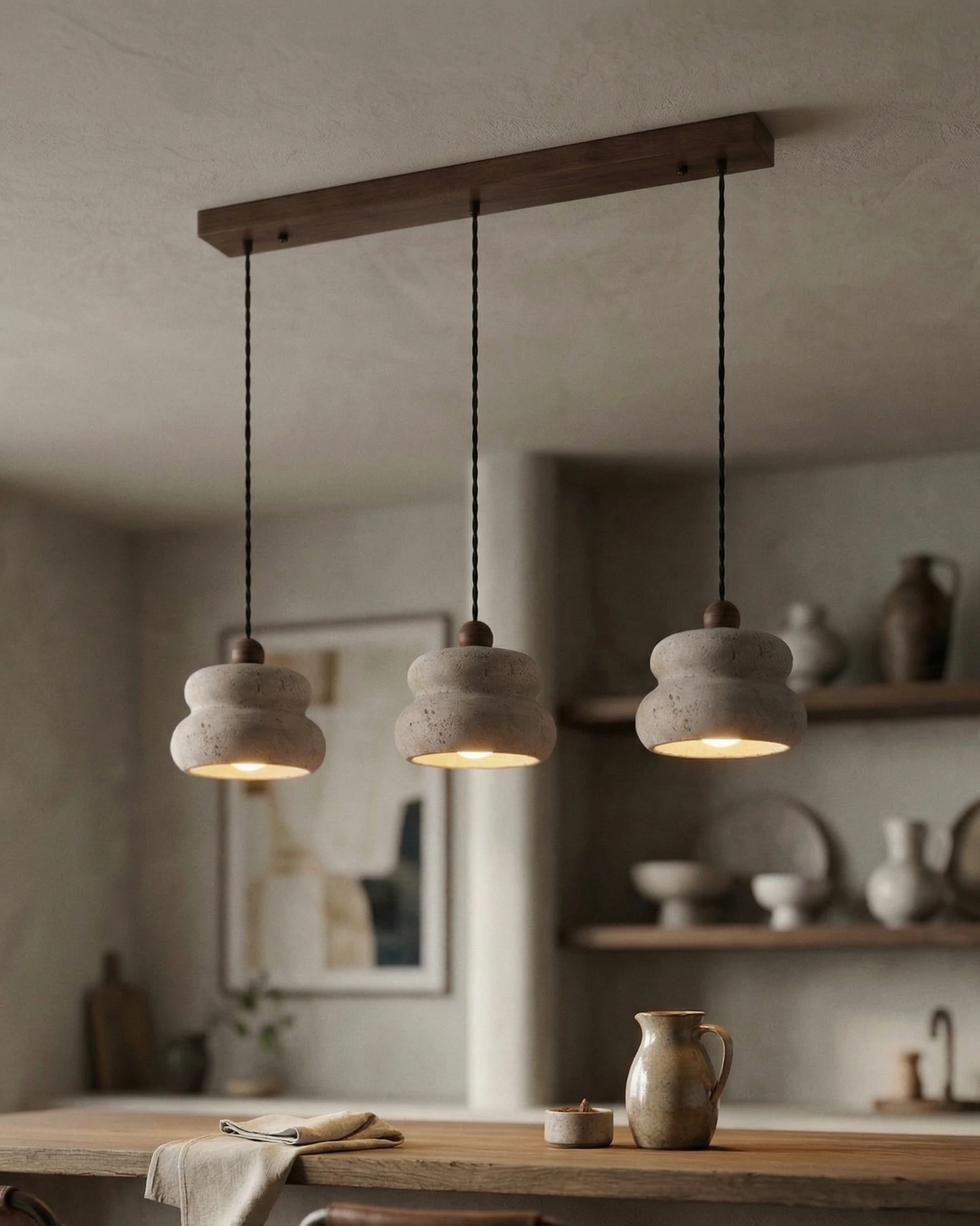 Three travertine pendant lights SOVA No.05 on a walnut bar switched on over a wooden counter with leather stools