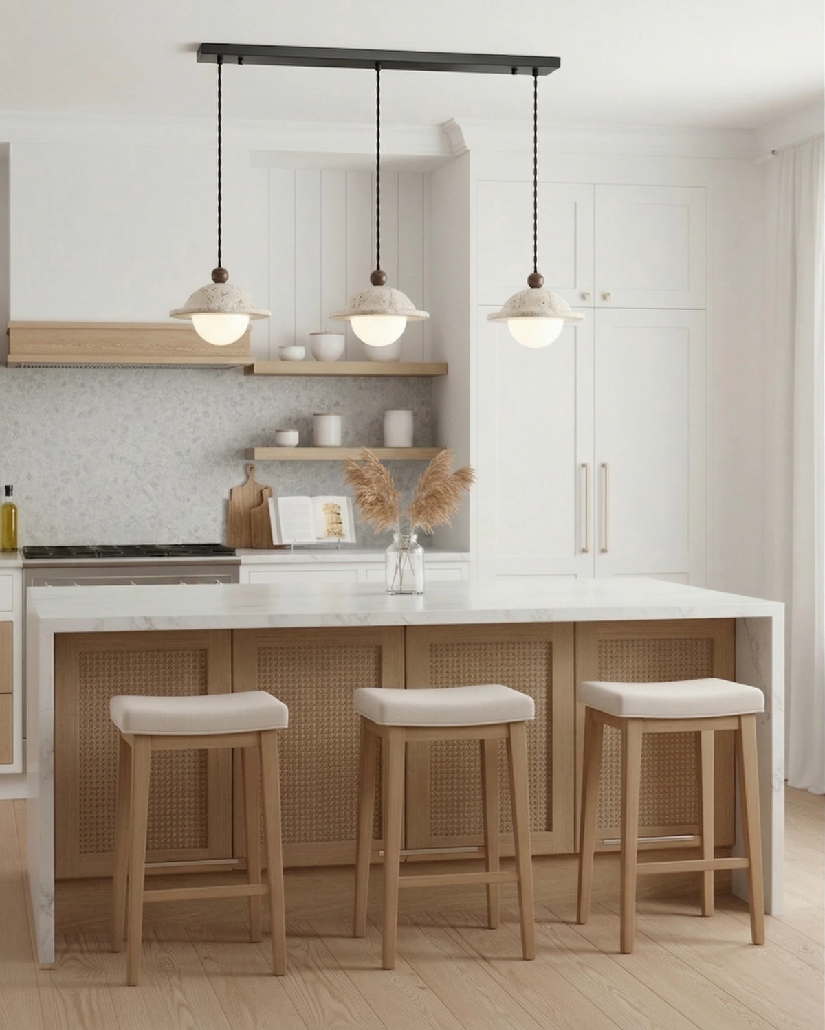 Travertine pendant light SOVA No.01, three saucer pendants lit over a white kitchen island with three oak stools
