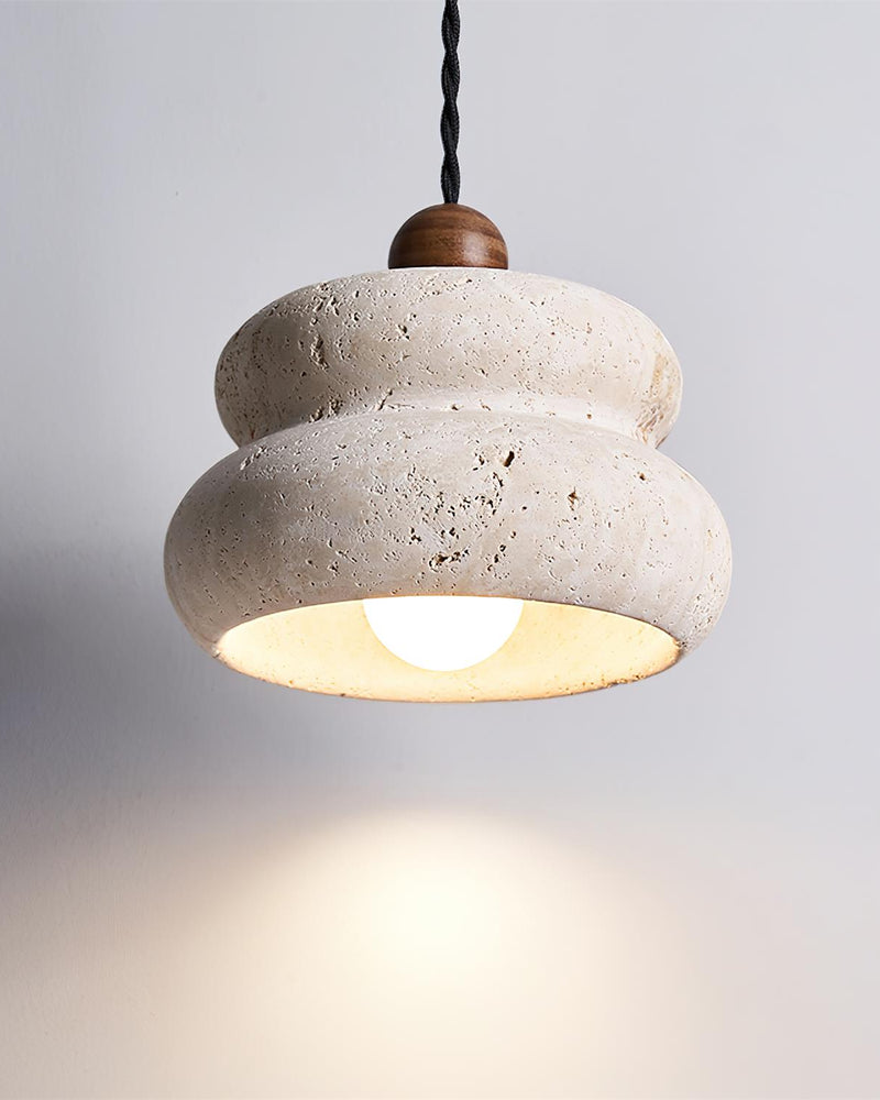 Travertine pendant light SOVA No.05 seen from below, lit bulb visible inside the cream stone pebble shade