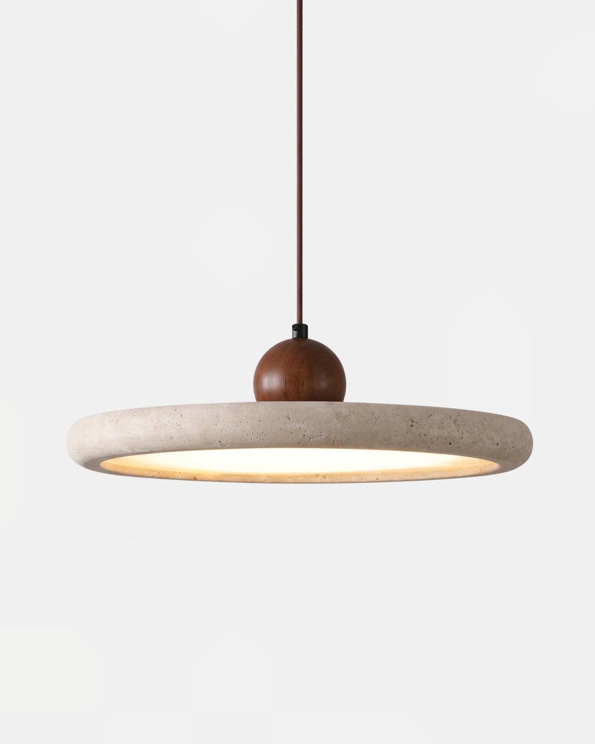 Travertine pendant light TONDO No.02 in the single 40 cm size, flat travertine ring on a brown cord, switched on