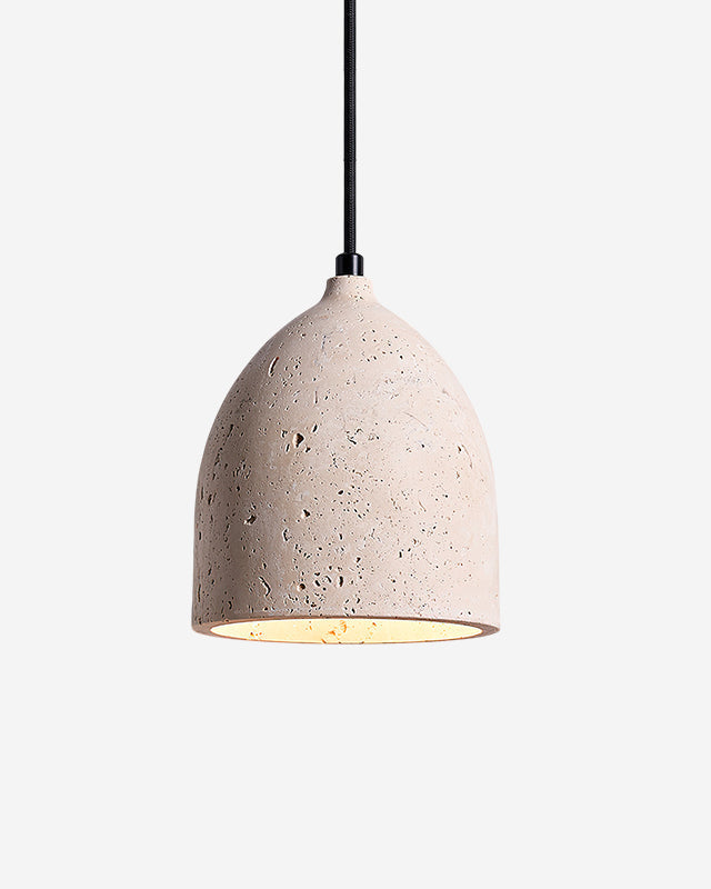 Travertine pendant light BOCCA No.01 in the single configuration, pitted stone bell on a black cord, switched on