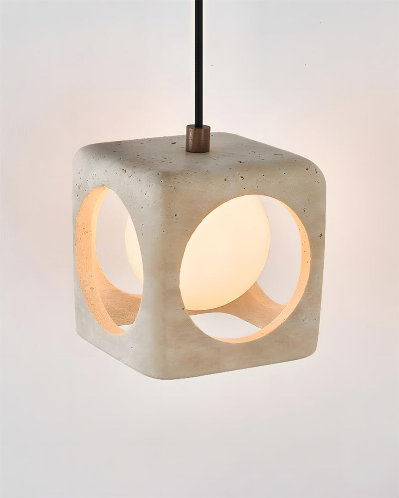 Travertine pendant light CUBA No.02 solo cube lit, angled view showing the bronze cord fitting on top