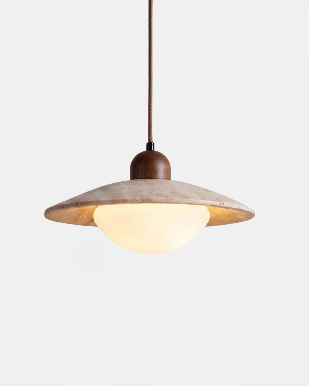 Travertine pendant light TONDO No.01, cream stone saucer with a glowing opal dome beneath and a walnut cap