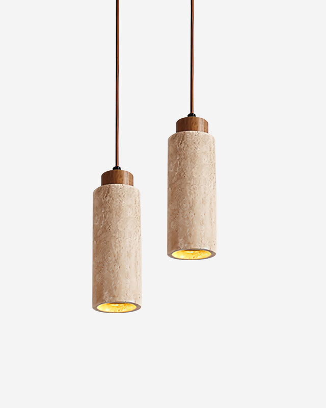 Two travertine pendant lights CORTO No.03 in cream at staggered heights on leather cords, both switched on