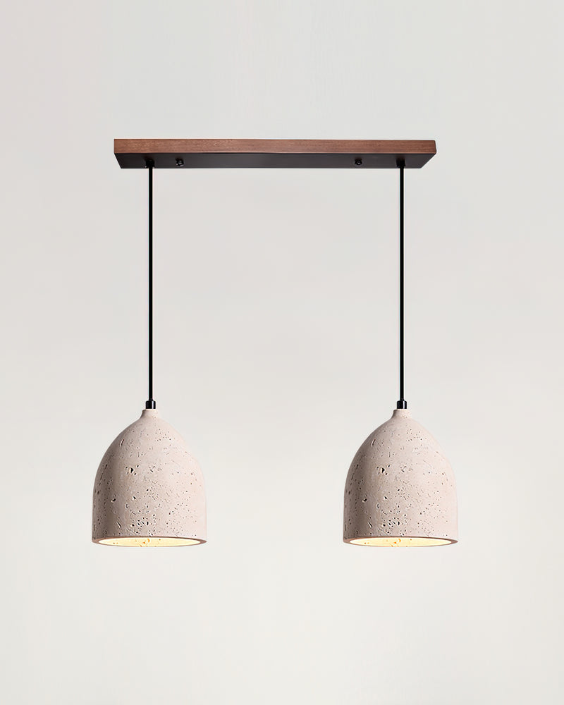 Two travertine pendant lights BOCCA No.01 in the double linear layout, lit bells hanging from a walnut bar