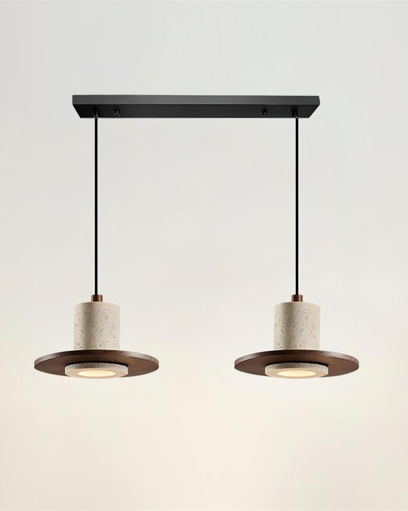Two travertine pendant lights TONDO No.04 Double, a pair of drums on walnut saucers hung from a black bar, switched on