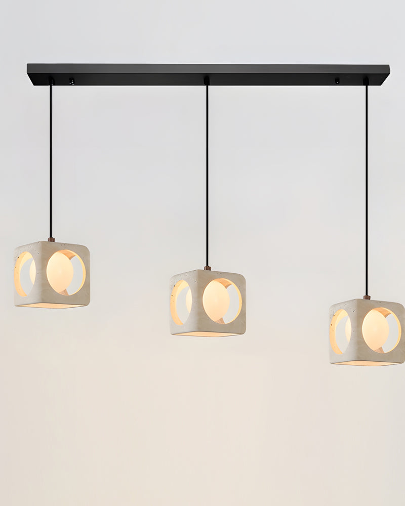 Travertine pendant light CUBA No.02 linear trio, three lit travertine cubes hanging from one black bar