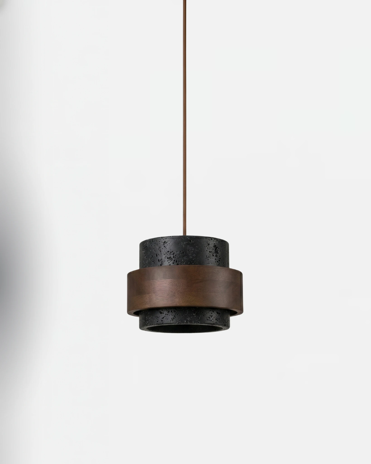 Travertine pendant light AVORIO No.05 in volcano black, dark stone drum with a walnut belt, unlit