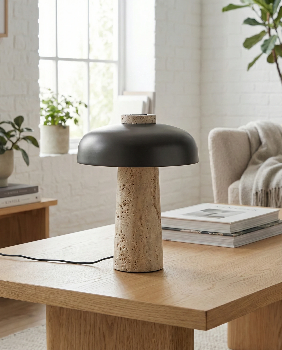 Travertine table lamp ROCCA No.03 with bronze shade on an oak desk with books by a bright window