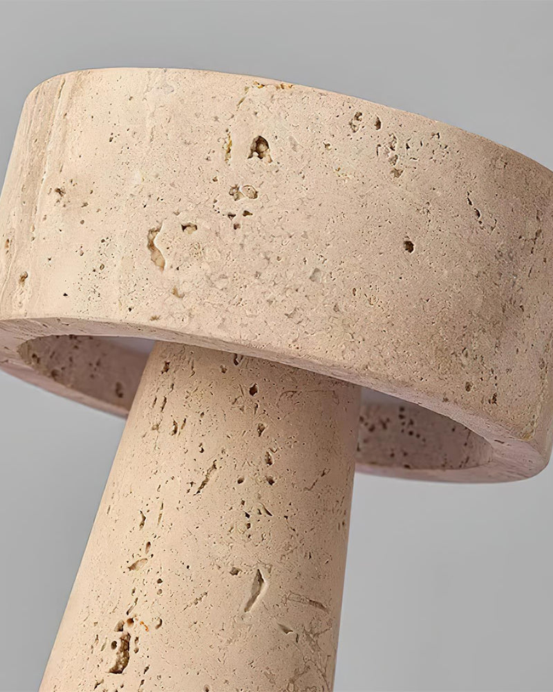 Close-up of the pitted travertine disc top and stem of the travertine table lamp MORA No.02, unlit