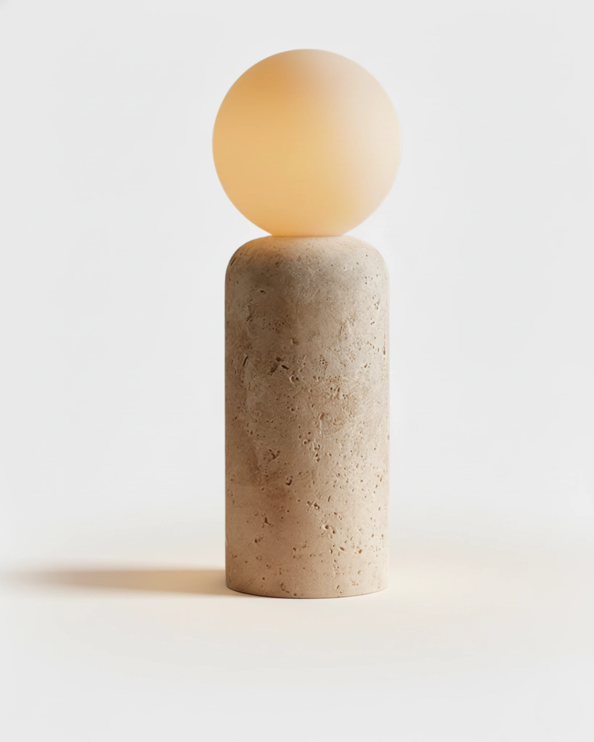 Travertine table lamp MORA No.04 Cylindrical in Cream Travertine, straight stone column under a lit opal globe
