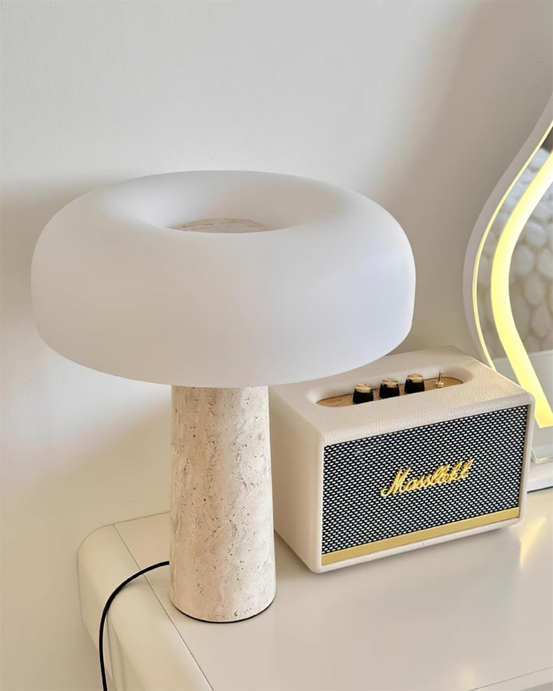 Travertine table lamp MORA No.03 on a white dresser beside a cream speaker and a lit mirror