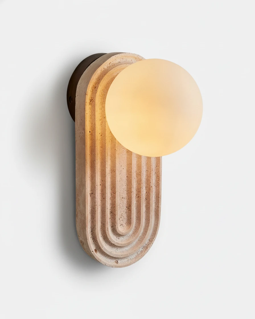 Travertine wall sconce ARCA No.01, fluted cream travertine arch with an opal globe switched on, white background