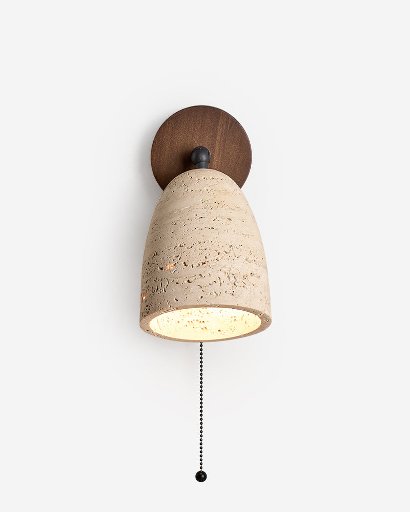 Travertine wall sconce PERA No.01 lit, small pivoting travertine dome and pull chain on a walnut backplate