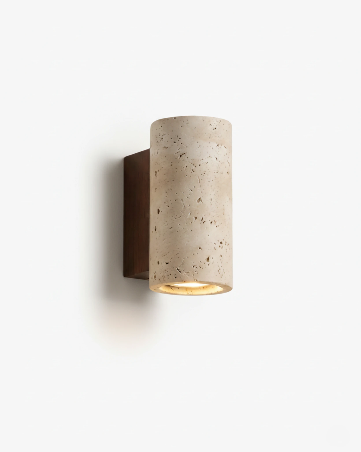 Travertine wall sconce GRANO No.02, yellow travertine cylinder on a dark wood bracket with the lens lit
