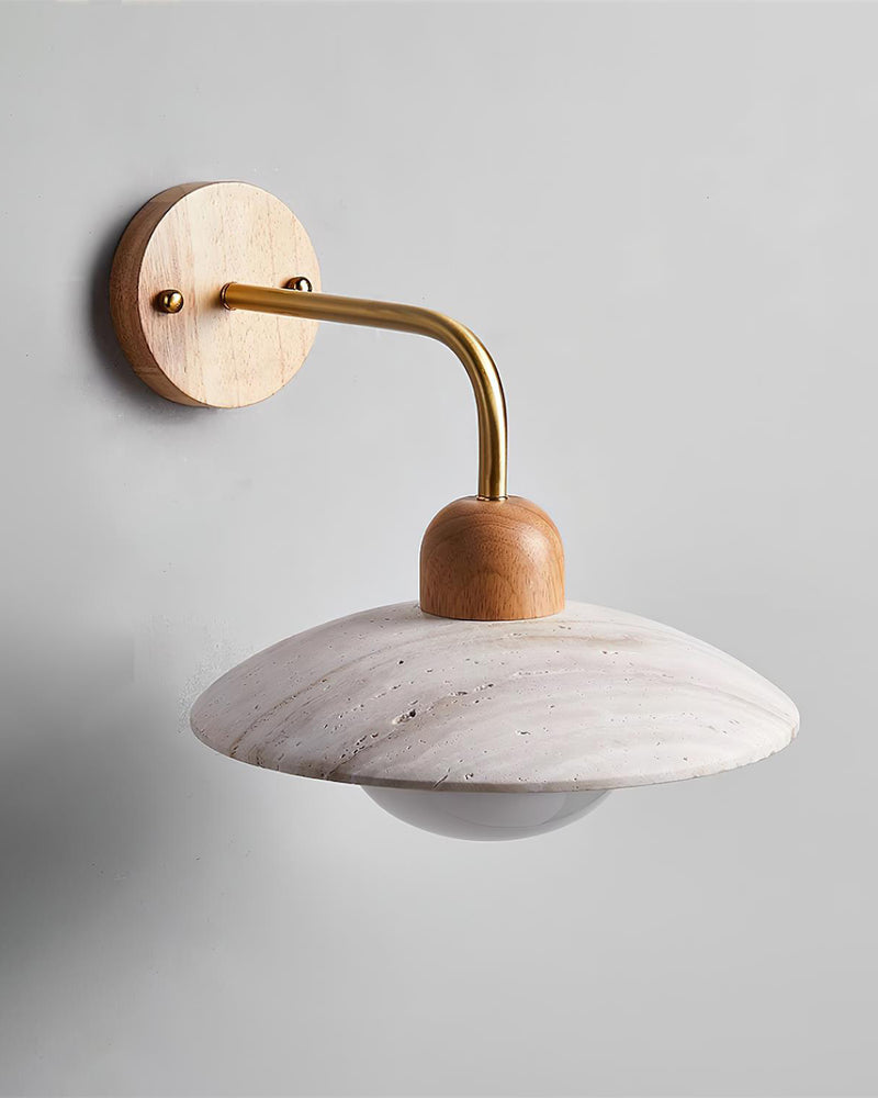 Travertine wall sconce IVERA No.01, natural wood cap on a brass arm with the opal globe off, angled view