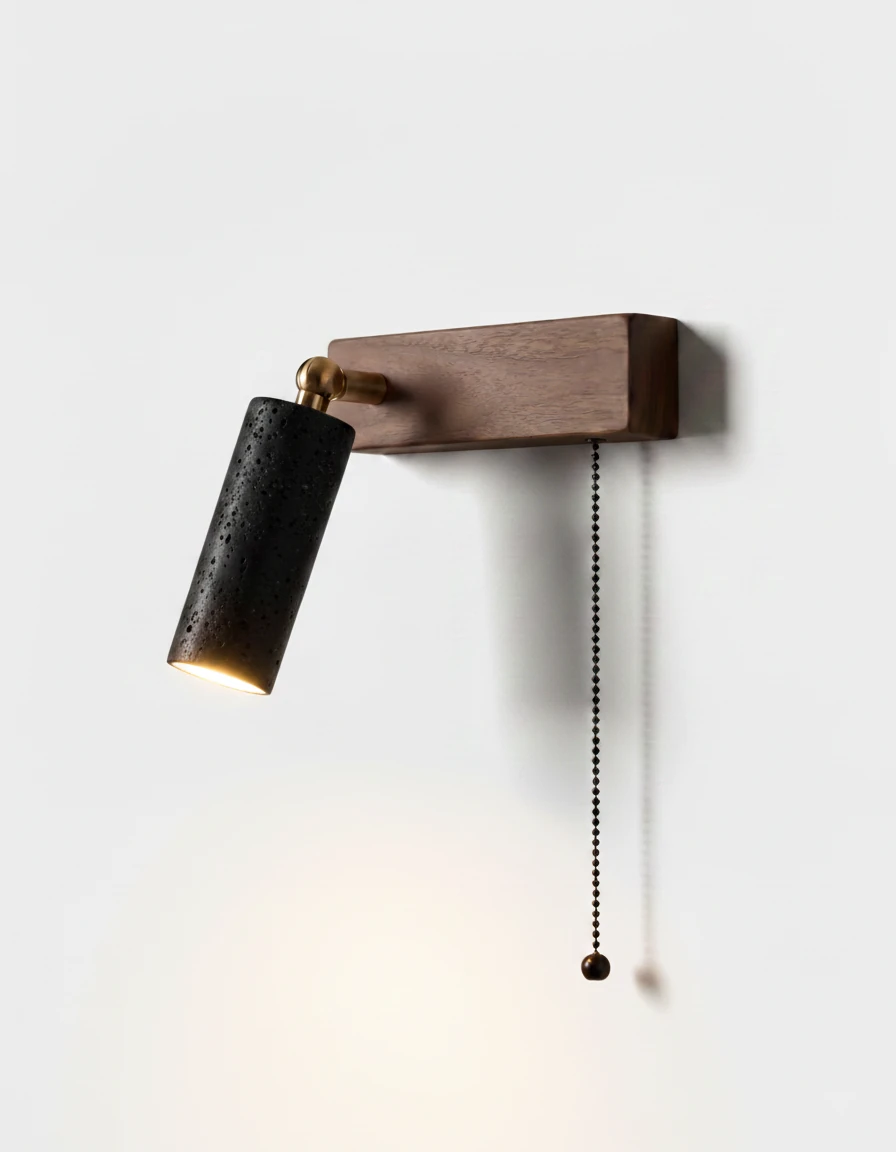 Travertine wall sconce VITRU No.01 in volcano black, left-hand head with pull chain on a walnut block, unlit