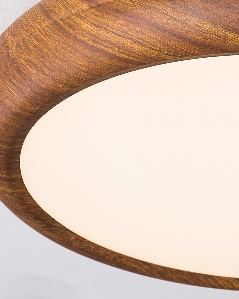 Close-up of the wood rim of the COMO No.01 meeting its warm lit diffuser, seen at an angle