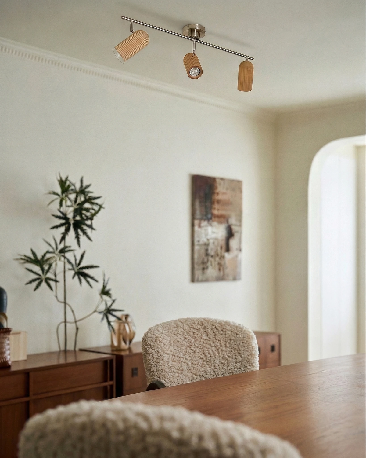 Wood flush mount ceiling light RIGA No.06 three-spot bar on the ceiling above a wooden dining table and chairs