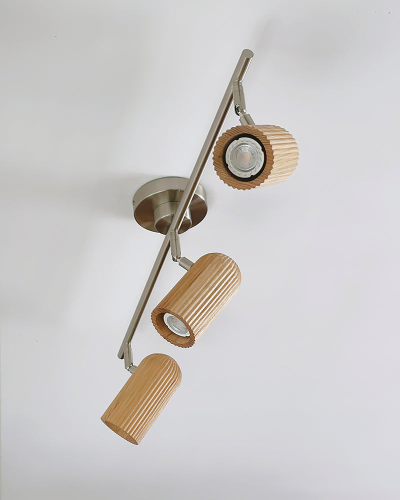 Wood flush mount ceiling light RIGA No.06 mounted diagonally with all three fluted spots switched on