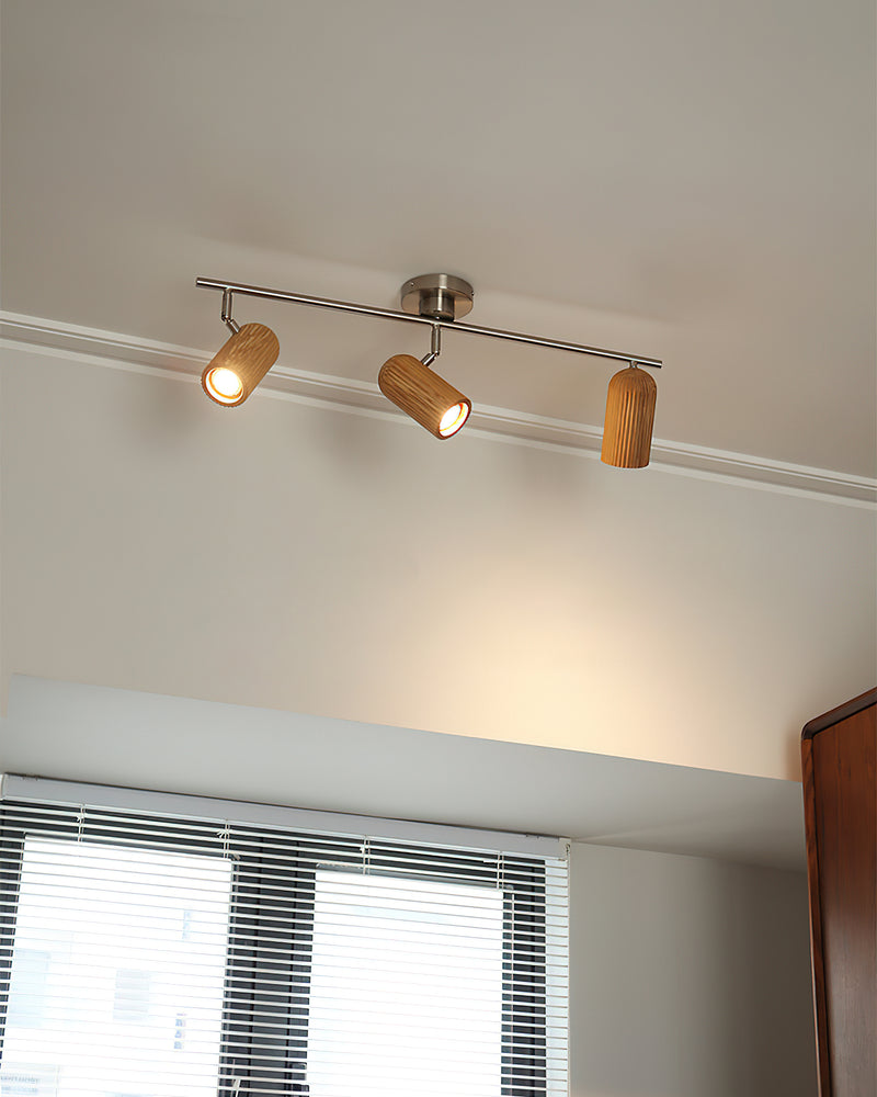 Wood flush mount ceiling light RIGA No.06 triple spot lit on a ceiling near a window with blinds