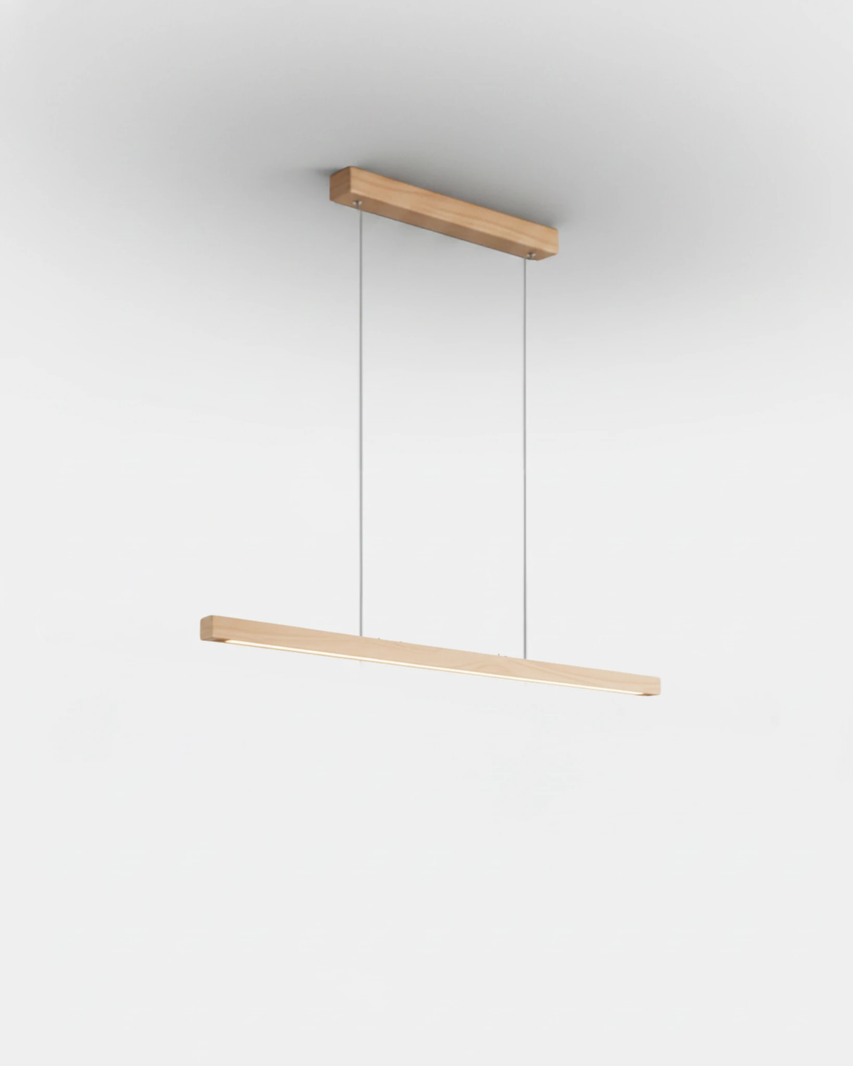 Wood pendant light VIRGA No.01, compact 31 in natural ash bar on two thin cables from a light wood canopy, lit