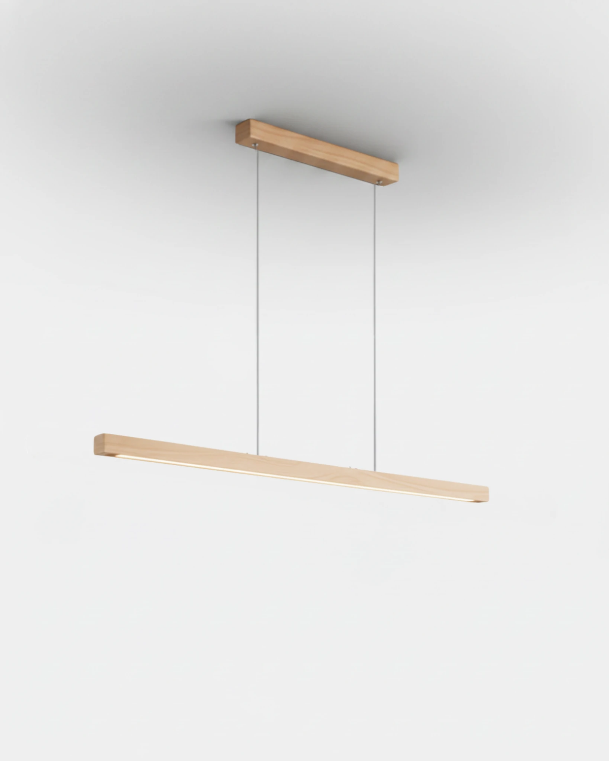 Wood pendant light VIRGA No.01 in the 39 in natural ash finish, blond wood bar with the LED glowing underneath