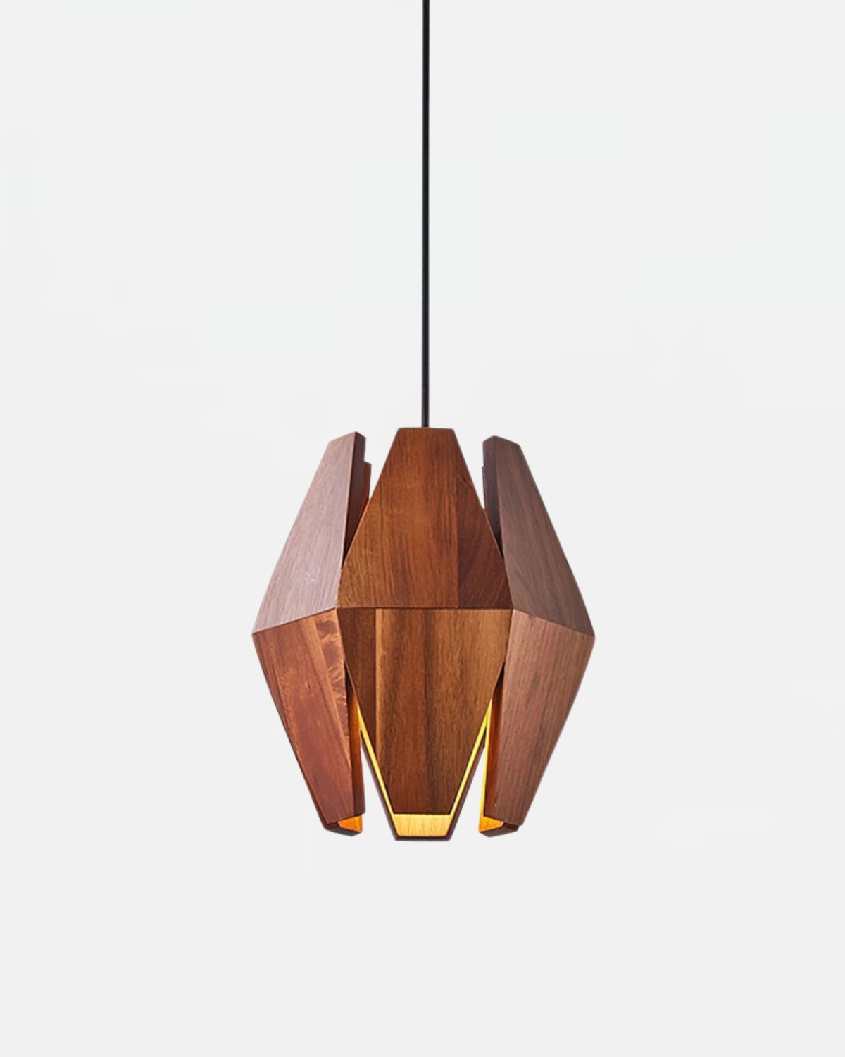 Wood pendant light ORBIT No.01 in Walnut on Brushed Brass, faceted walnut fins switched on with a warm glow inside
