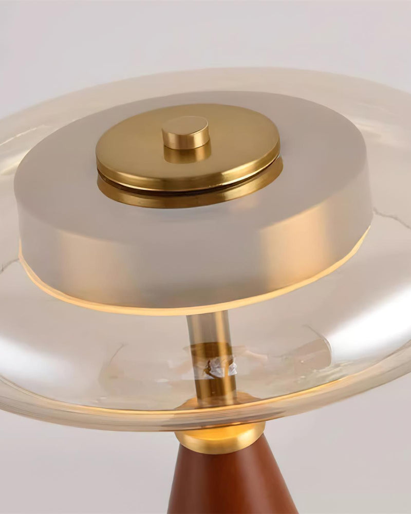 Close-up of the cognac ribbed glass shade and brass finial of the wood table lamp ROCCA No.01, lit