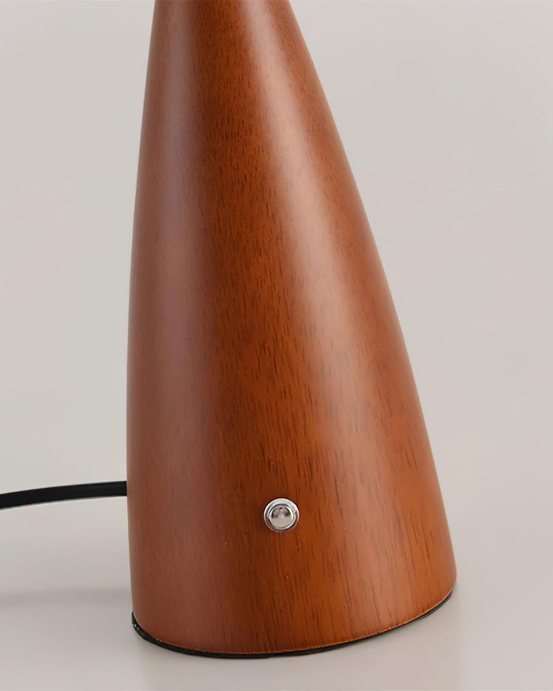 Close-up of the walnut cone base with touch button and cord on the wood table lamp ROCCA No.01