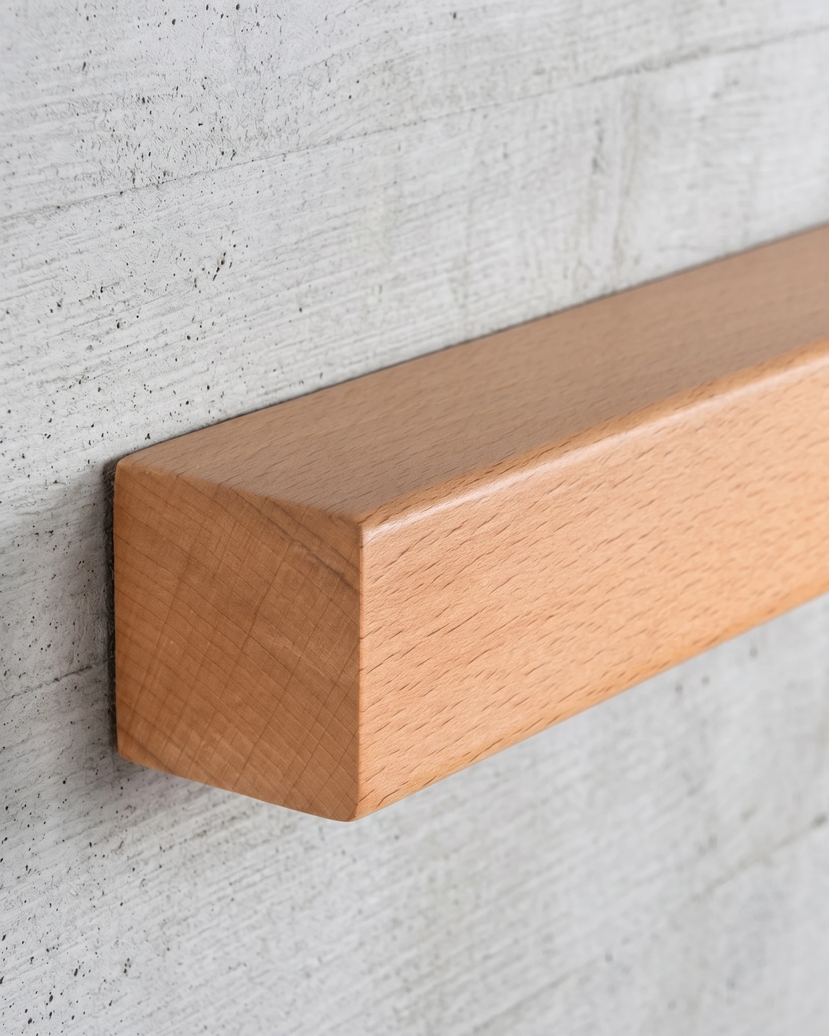 Close-up of the light walnut bar end of the PIANO No.01 against a concrete wall, unlit