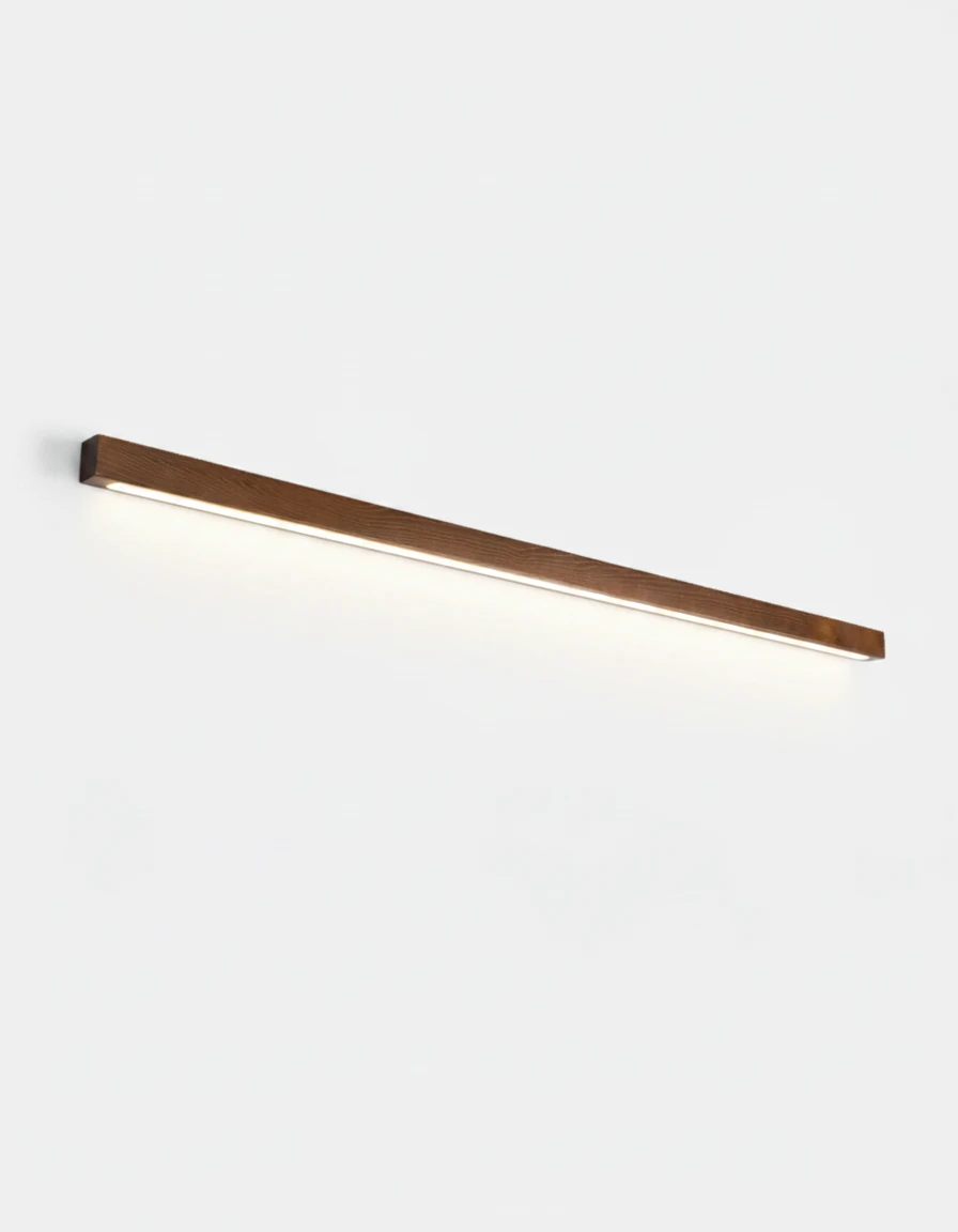 Wood wall sconce PIANO No.01, 100 cm dark walnut bar casting down-only light on a white wall